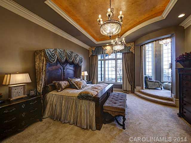 16505 Jetton Road Cornelius, NC 28031 - Photo 14 of 23 a bedroom with a bed and a chandelier