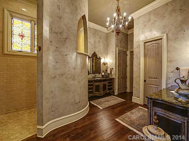 16505 Jetton Road Cornelius, NC 28031 - Photo 16 of 23 a bathroom with a granite countertop sink a mirror and shower