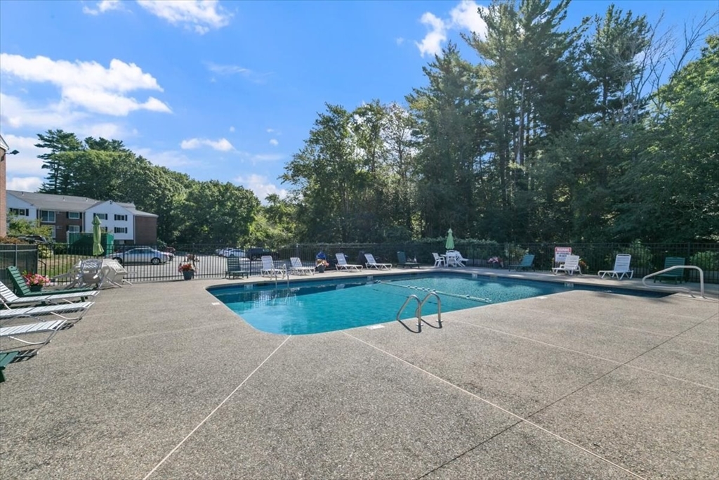 25 Clark's Road, Unit 101 Amesbury, MA 01913 - Photo 27 of 32 a swimming pool with outdoor seating and yard