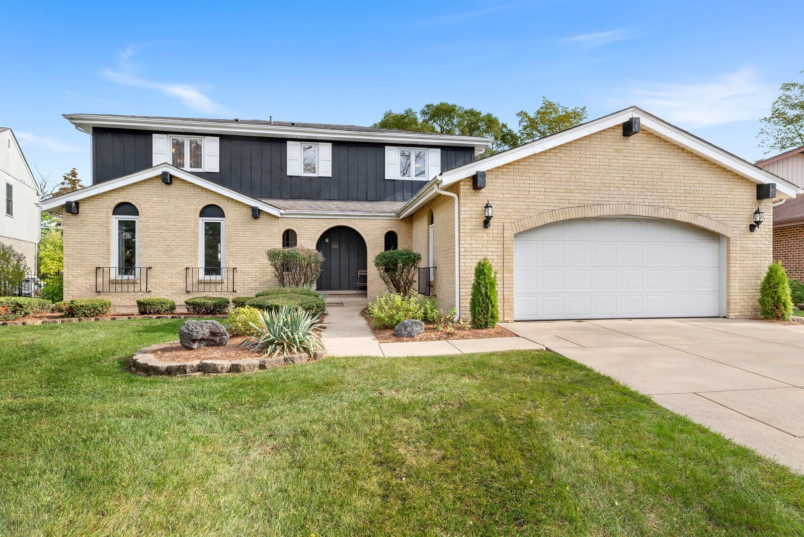1133 Old Fence Road Addison, IL 60101 - Photo 2 of 29 a front view of a house with a garden and yard