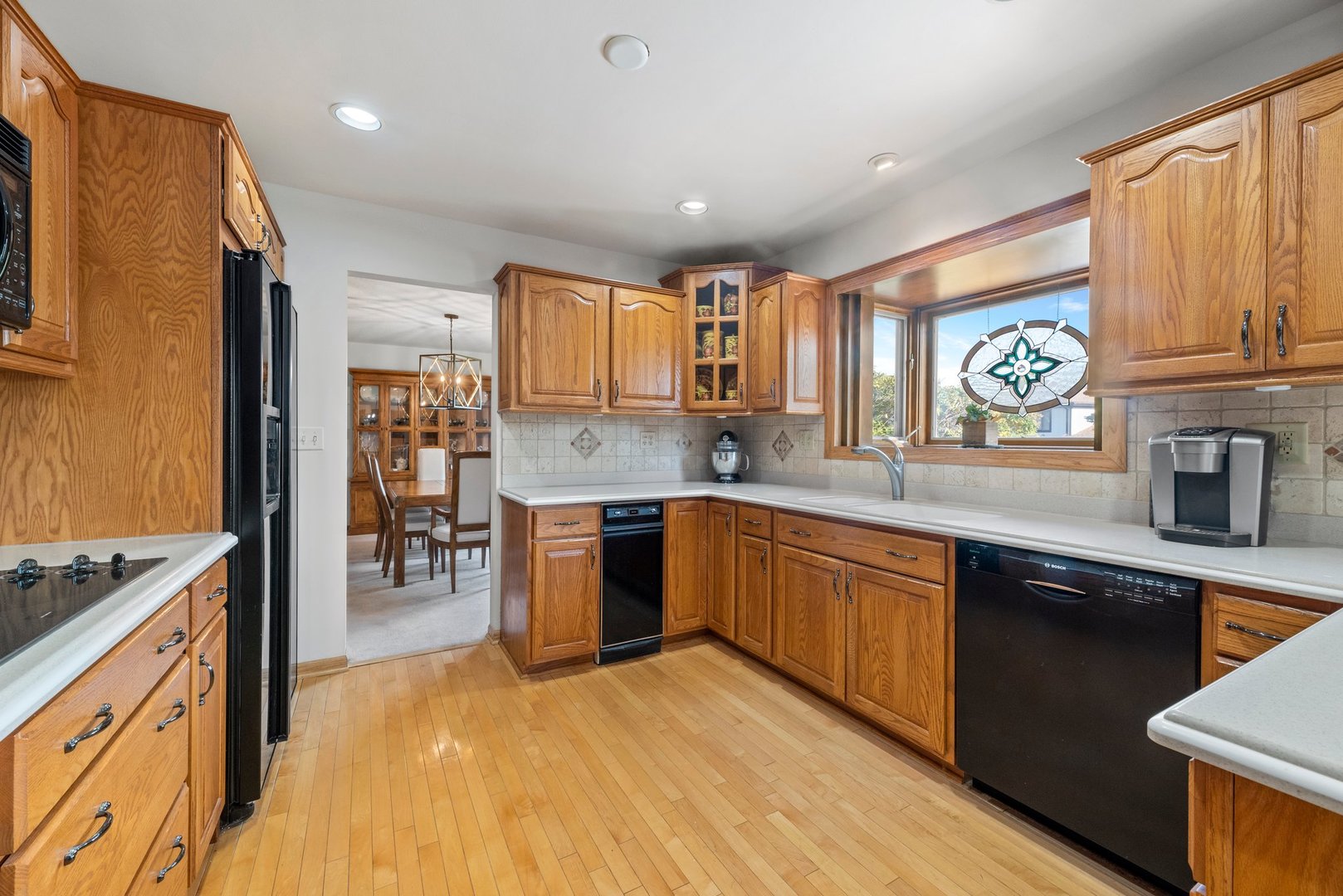 1133 Old Fence Road Addison, IL 60101 - Photo 8 of 29 a kitchen with stainless steel appliances granite countertop a sink stove and wooden cabinets