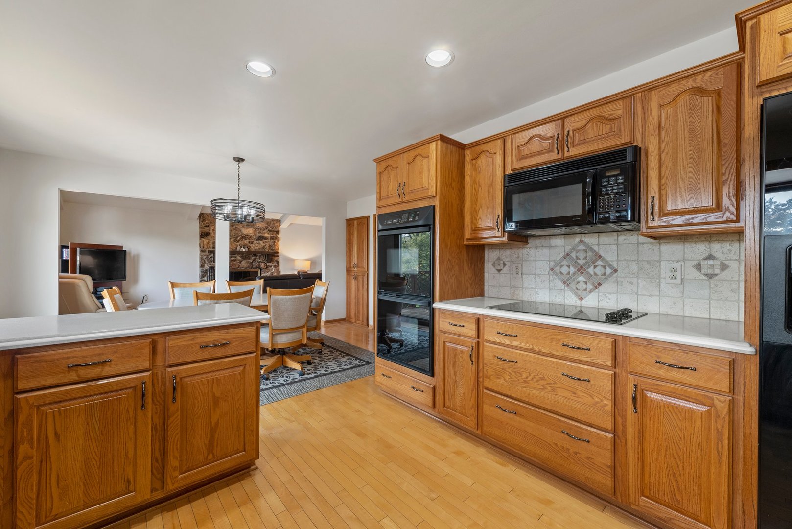 1133 Old Fence Road Addison, IL 60101 - Photo 9 of 29 a kitchen with stainless steel appliances granite countertop a stove microwave and cabinets