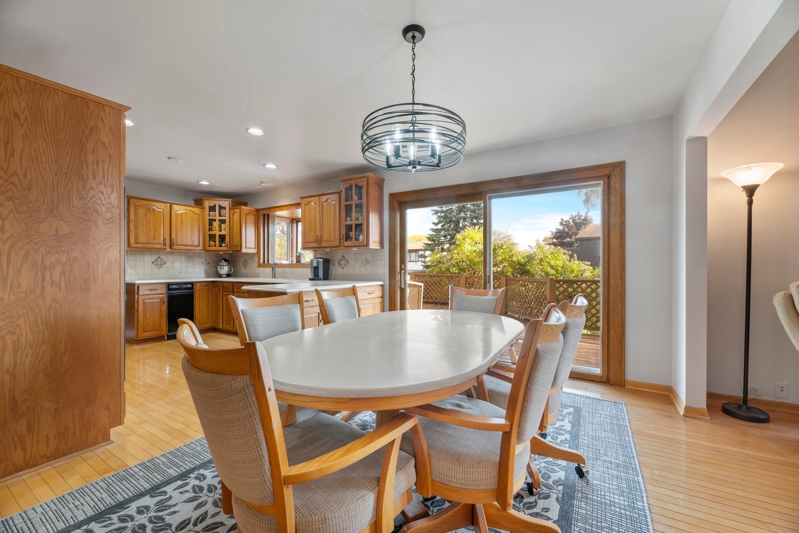 1133 Old Fence Road Addison, IL 60101 - Photo 10 of 29 a dining room with furniture a chandelier and wooden floor