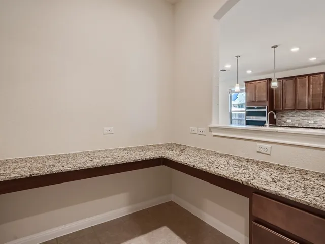 a view of a kitchen with granite countertop cabinets and a sink