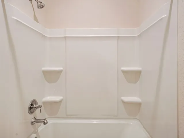 a bathroom with a shower a toilet and sink