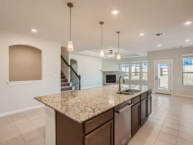 a kitchen with kitchen island a counter space a sink appliances and a counter top space