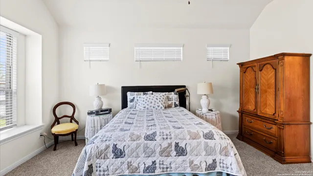 a large bed sitting in a bedroom next to a window