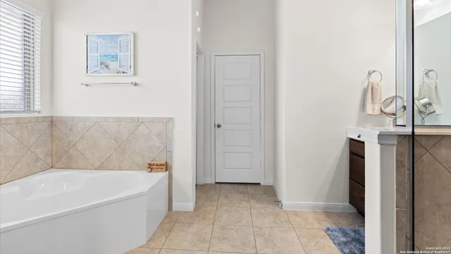 a bathroom with a bathtub and shower