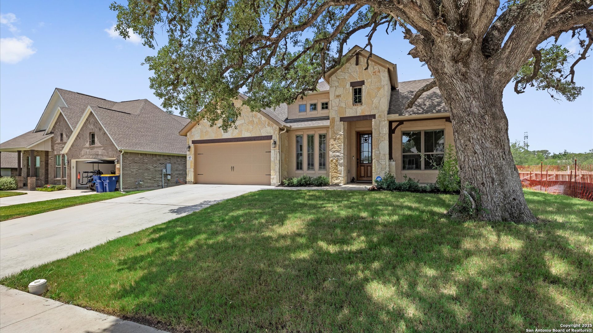 425 Foxbrook Way Cibolo, TX 78108 - Photo 2 of 29 a front view of a house with a garden and trees