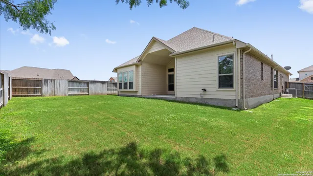 a view of a house with a yard and sitting area