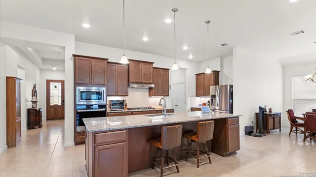 a large kitchen with a table and chairs