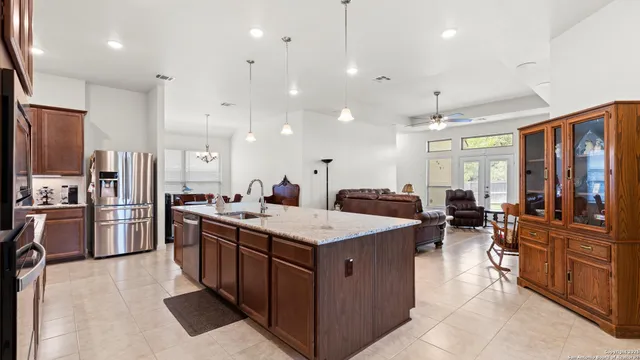 a large kitchen with stainless steel appliances lots of counter space and windows