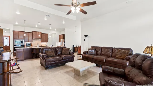 a living room with furniture and kitchen view