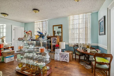 a living room filled with furniture and a chandelier