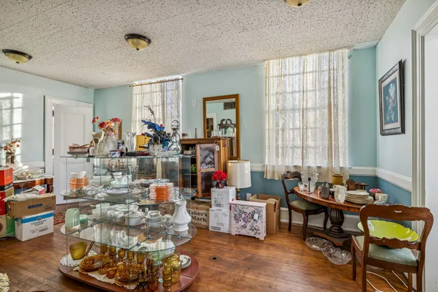 a living room filled with furniture and a chandelier