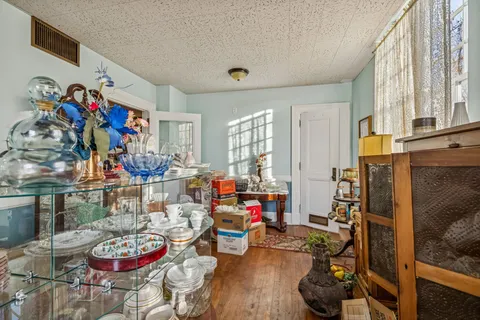 a view of living room with furniture and wooden floor