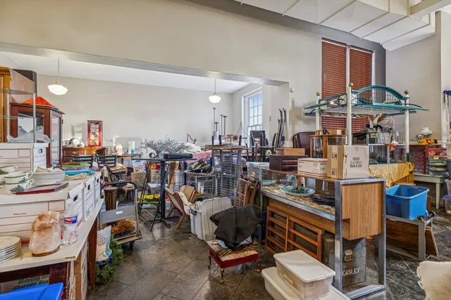 a room with furniture a rug toys and a large window