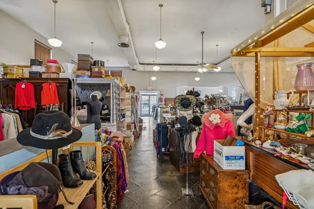 a room with lots of wooden furniture and a view of living room