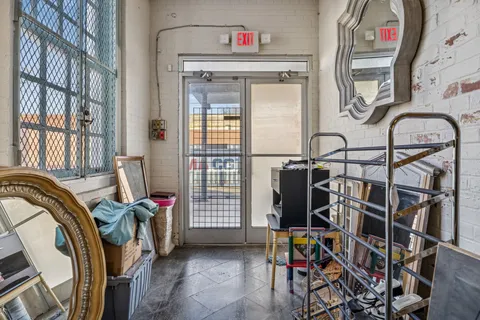 a view of a livingroom with furniture and a window