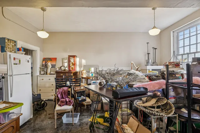 a living room with furniture chess board and a couch