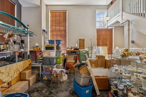 a living room with furniture a flat screen tv and a large window