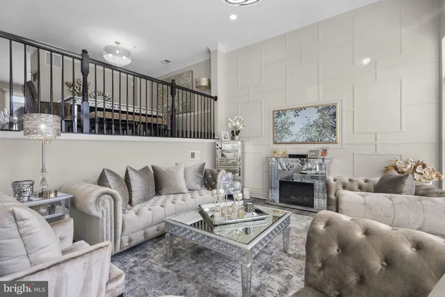 a living room with furniture fireplace and kitchen view