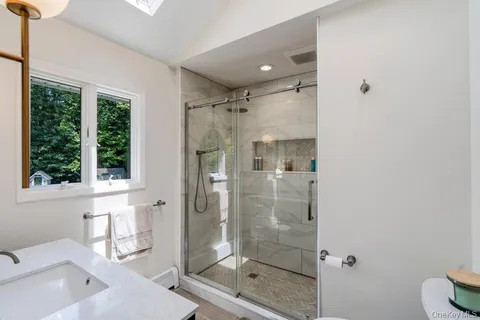 a bathroom with a shower and a sink