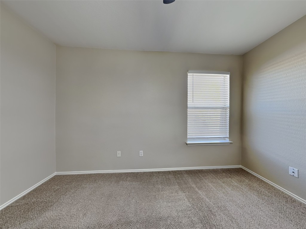 228 Fall Creek Drive Kyle, TX 78640 - Photo 12 of 19 Carpeted empty room with baseboards