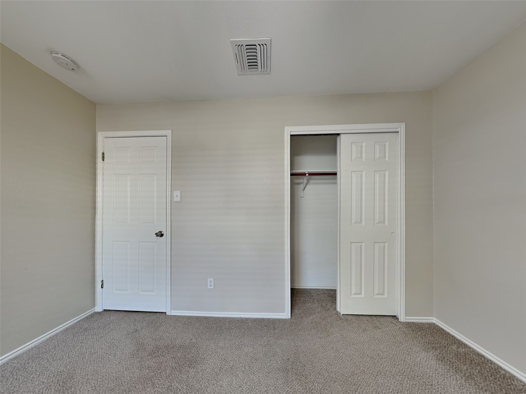 228 Fall Creek Drive Kyle, TX 78640 - Photo 13 of 19 Unfurnished bedroom with carpet floors and a closet