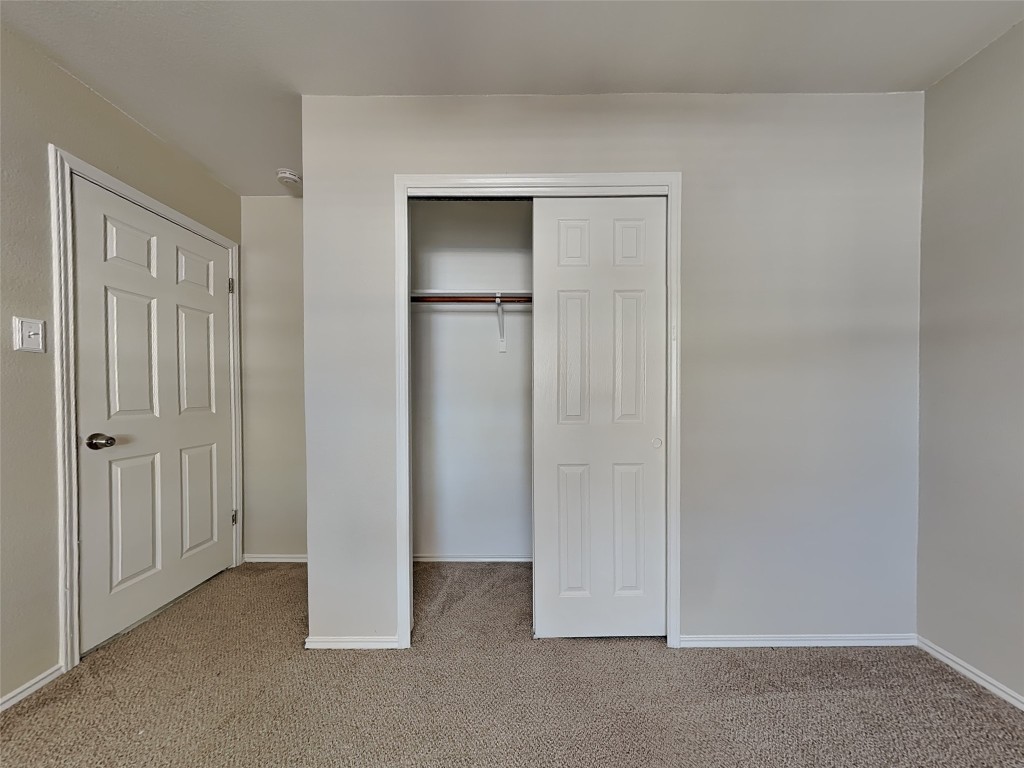 228 Fall Creek Drive Kyle, TX 78640 - Photo 14 of 19 Unfurnished bedroom with light carpet and a closet