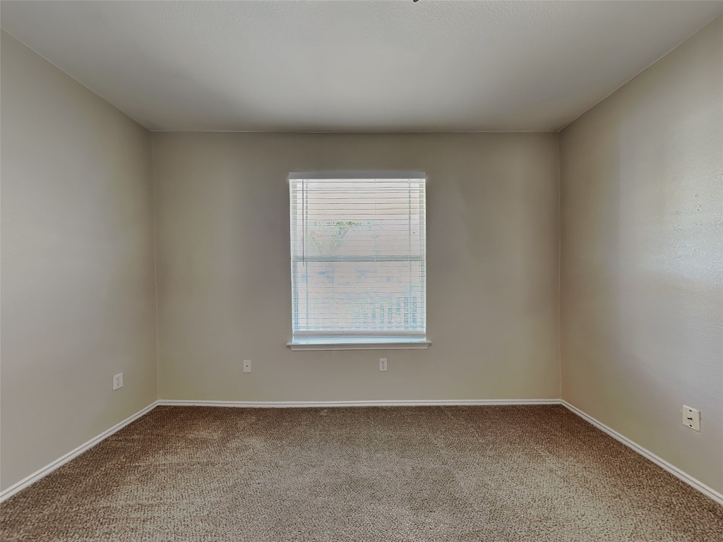 228 Fall Creek Drive Kyle, TX 78640 - Photo 15 of 19 Carpeted empty room featuring baseboards