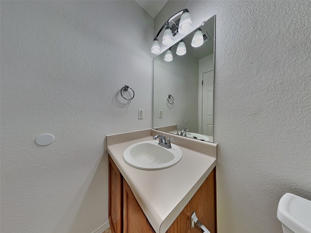 228 Fall Creek Drive Kyle, TX 78640 - Photo 17 of 19 Half bath with a textured wall and vanity