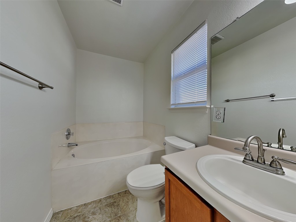228 Fall Creek Drive Kyle, TX 78640 - Photo 10 of 19 Bathroom with a bath and vanity