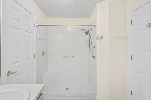 an empty room with a window and a ceiling fan