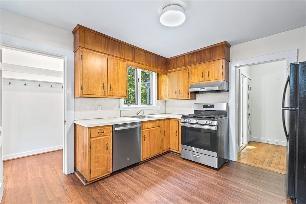 17 Colburn Road Wellesley, MA 02481 - Photo 14 of 30 a kitchen with stainless steel appliances granite countertop a refrigerator a sink dishwasher and a stove with wooden floor