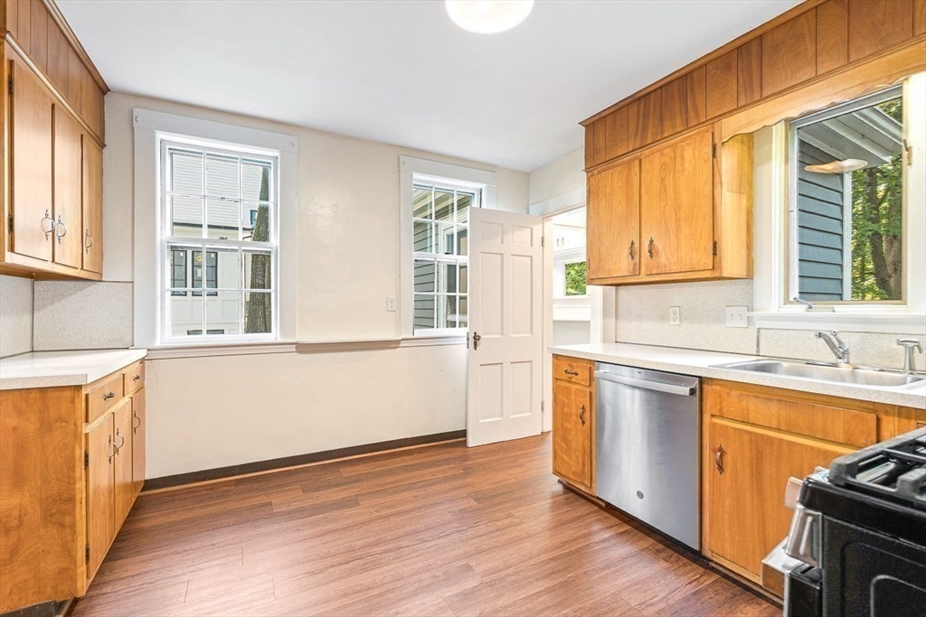 17 Colburn Road Wellesley, MA 02481 - Photo 15 of 30 a kitchen with stainless steel appliances granite countertop a sink a stove a refrigerator wooden floor and a large window