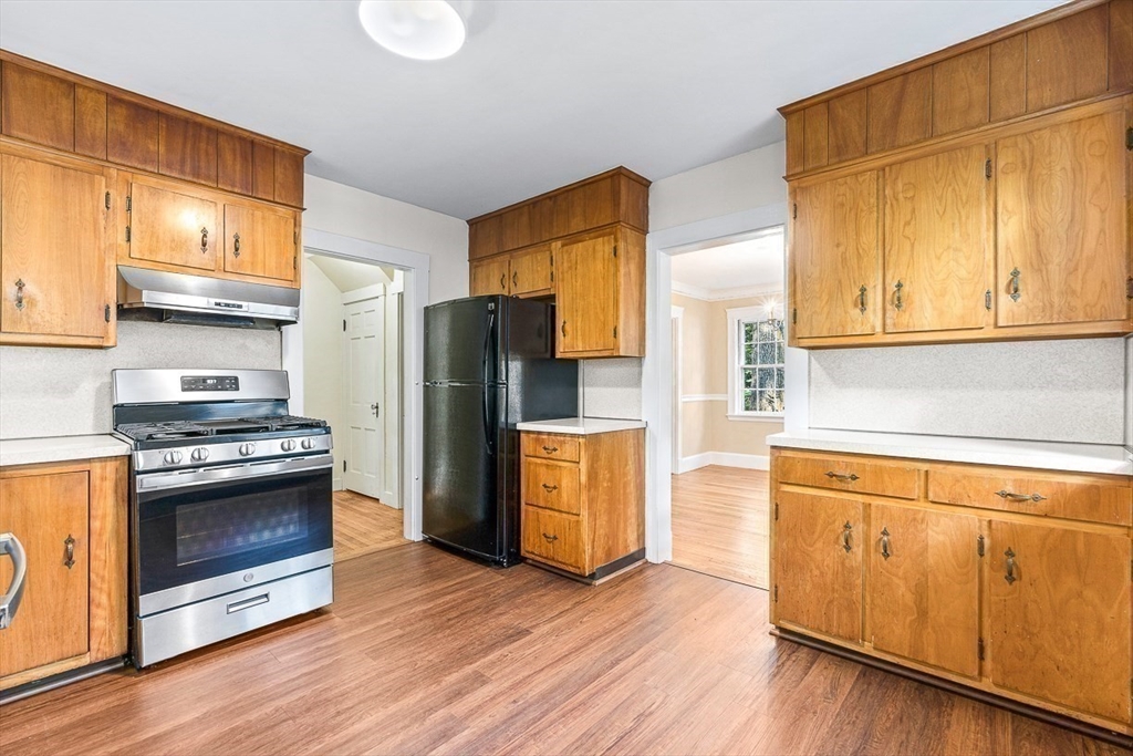 17 Colburn Road Wellesley, MA 02481 - Photo 16 of 30 a kitchen with stainless steel appliances granite countertop a refrigerator a stove and a wooden floors
