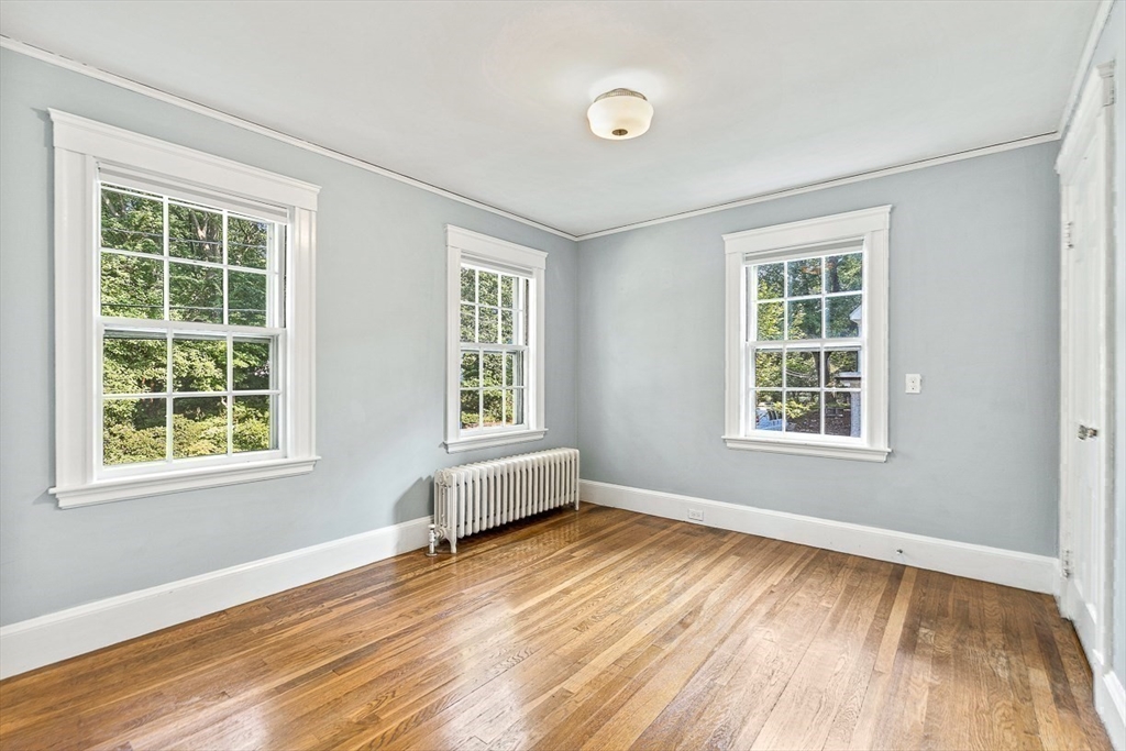 17 Colburn Road Wellesley, MA 02481 - Photo 20 of 30 an empty room with wooden floor and windows
