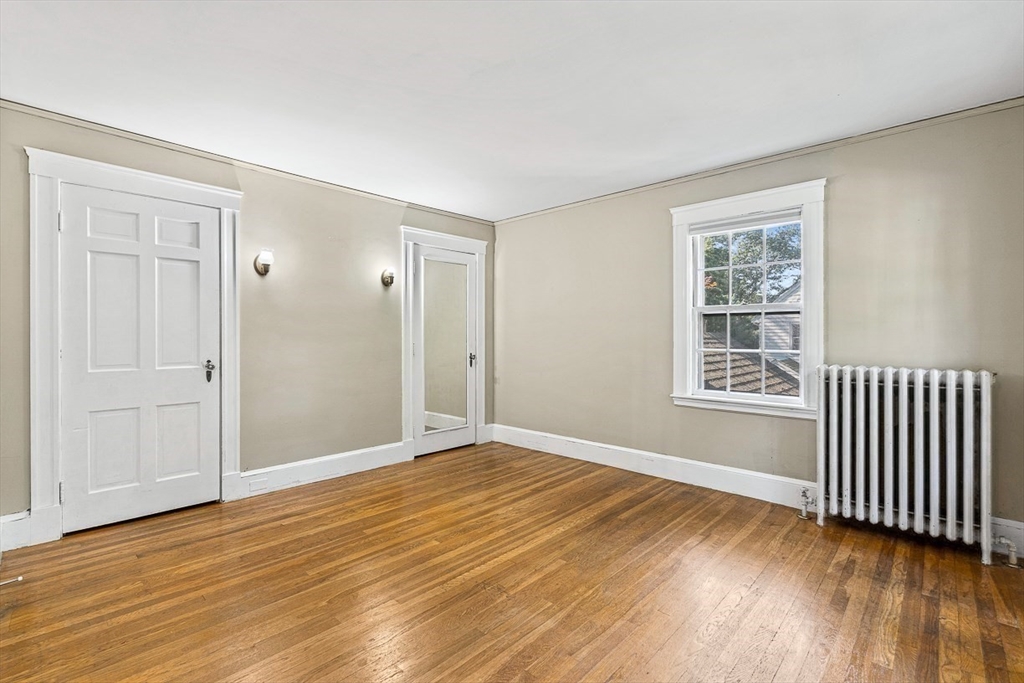 17 Colburn Road Wellesley, MA 02481 - Photo 21 of 30 a view of an empty room with wooden floor and a window