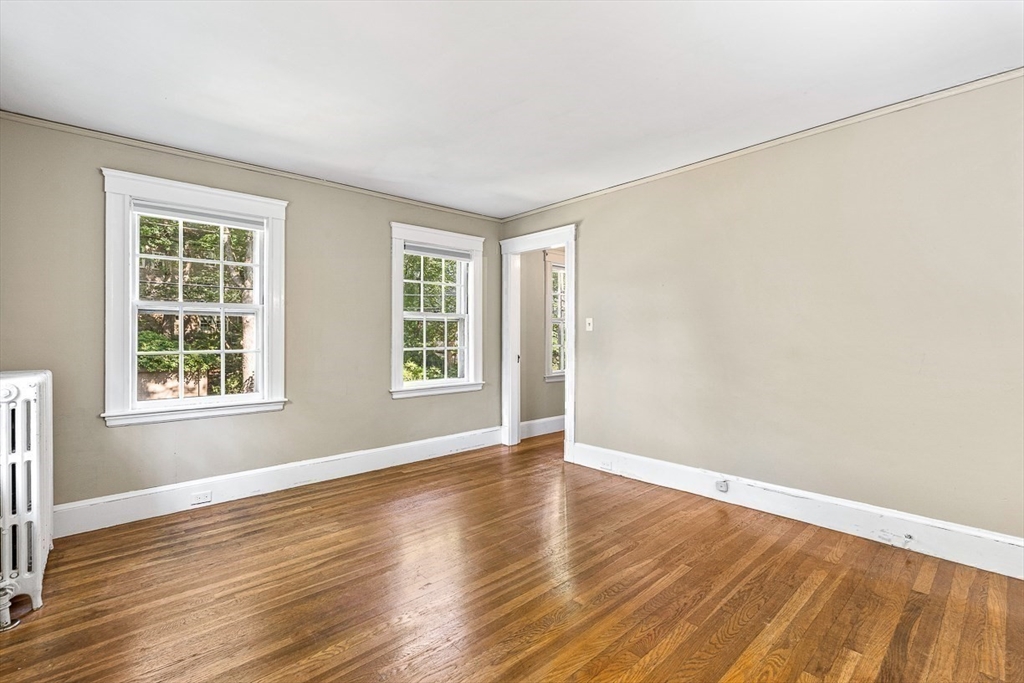 17 Colburn Road Wellesley, MA 02481 - Photo 22 of 30 an empty room with wooden floor and windows