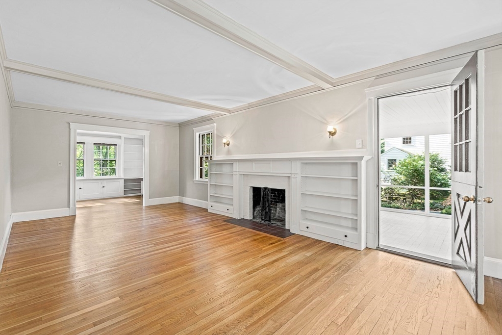 17 Colburn Road Wellesley, MA 02481 - Photo 5 of 30 a view of a livingroom with wooden floor a fireplace and windows