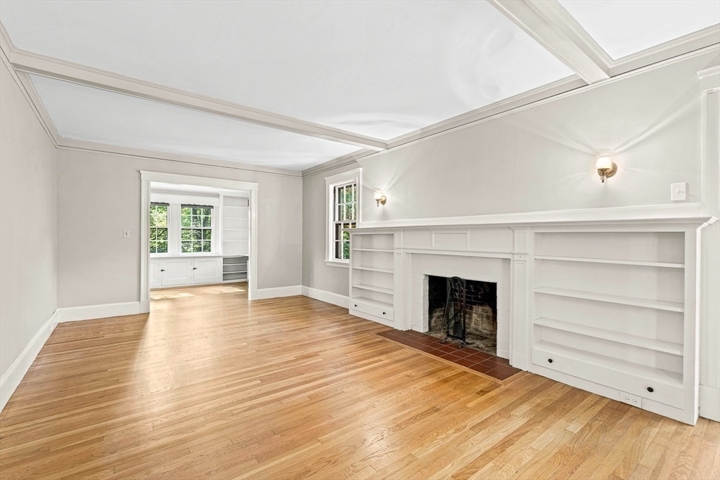 17 Colburn Road Wellesley, MA 02481 - Photo 6 of 30 a view of an empty room with wooden floor fireplace and a window