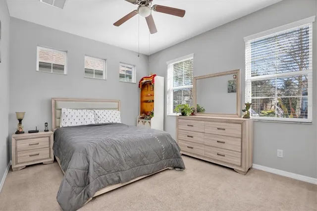 a bathroom with a granite countertop sink a toilet a mirror and shower
