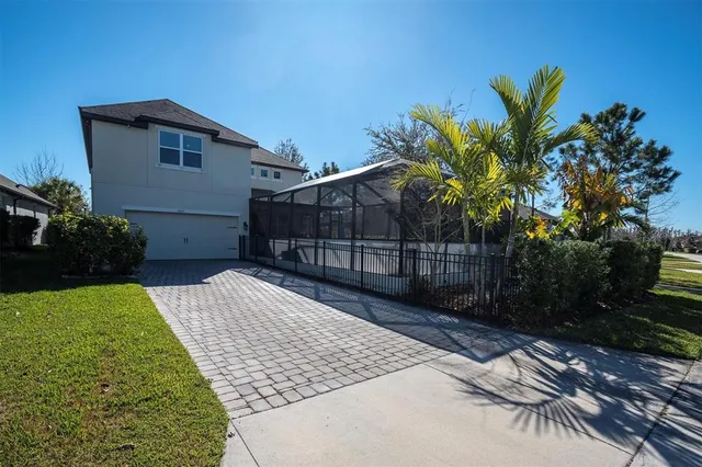 a view of backyard with potted plants and wooden fence