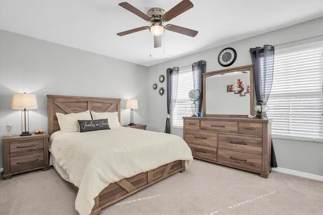 a bedroom with a bed dresser and a window