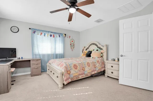a work room with furniture and a flat screen tv
