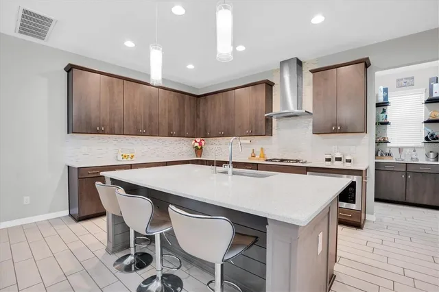 a kitchen with a sink cabinets and wooden floor