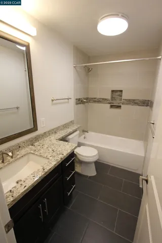 a bathroom with a shower and a sink