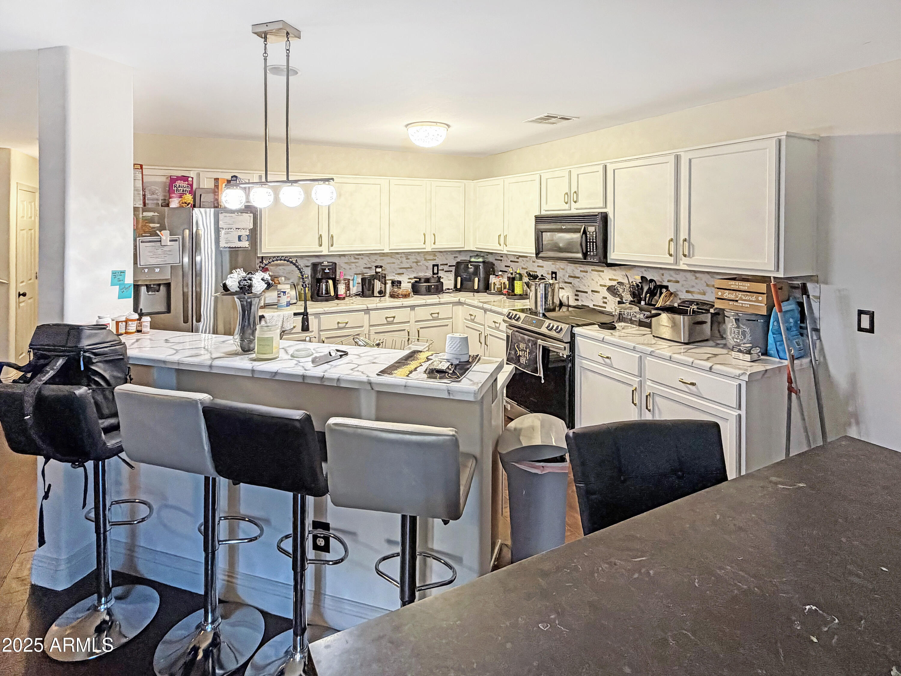 166 South 18 TH Street Coolidge, AZ 85128 - Photo 5 of 31 a kitchen with a table chairs stove and cabinets