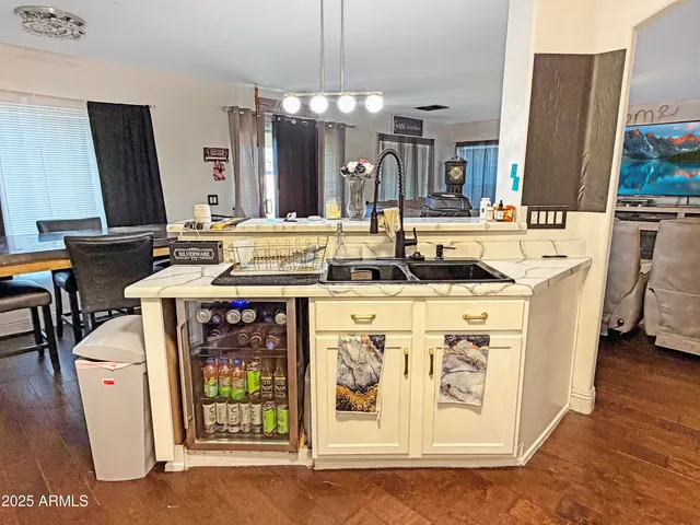 a kitchen with appliances a sink and cabinets